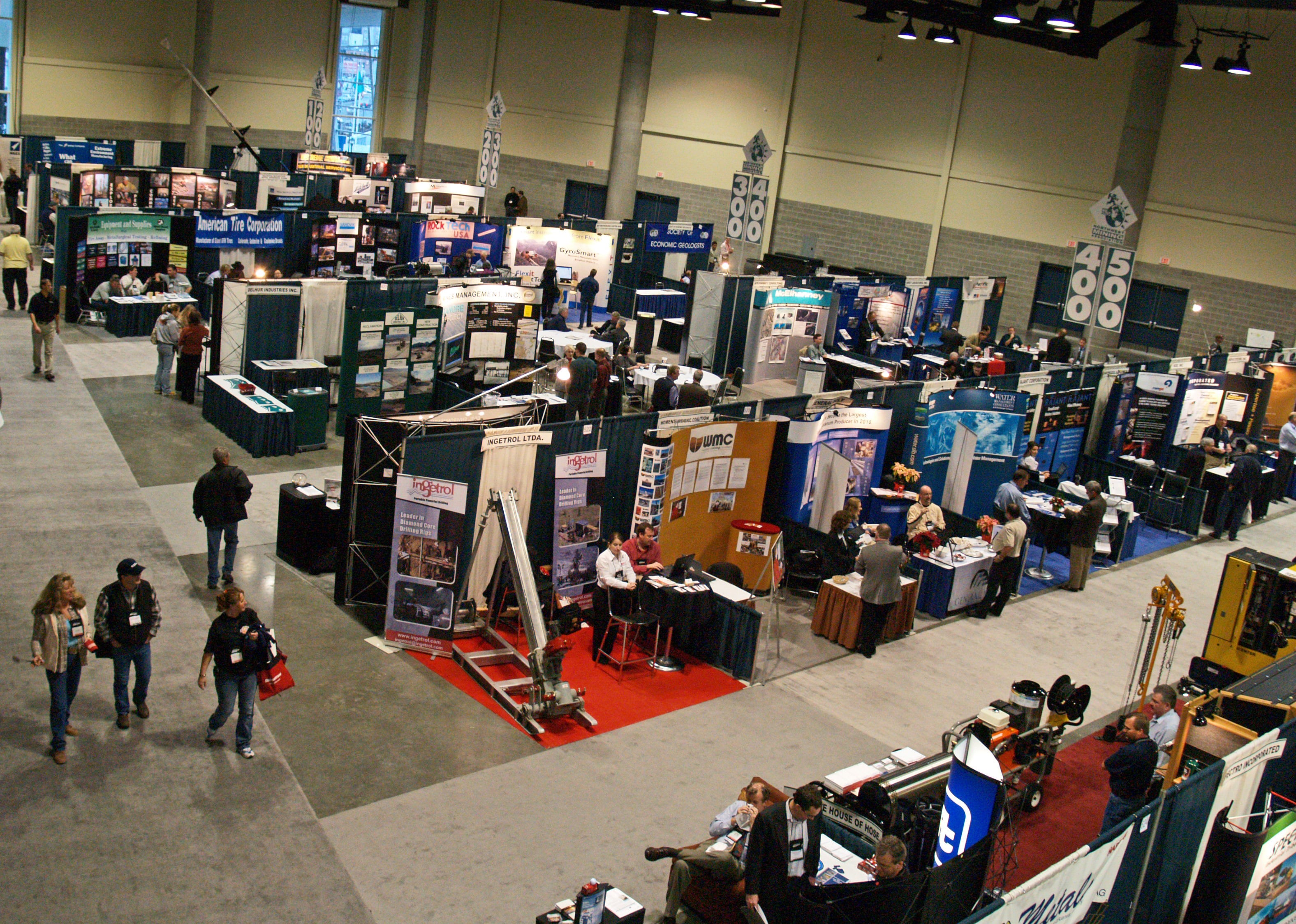 An exhibition floor with booths, displays and attendees at an LCD Expo event