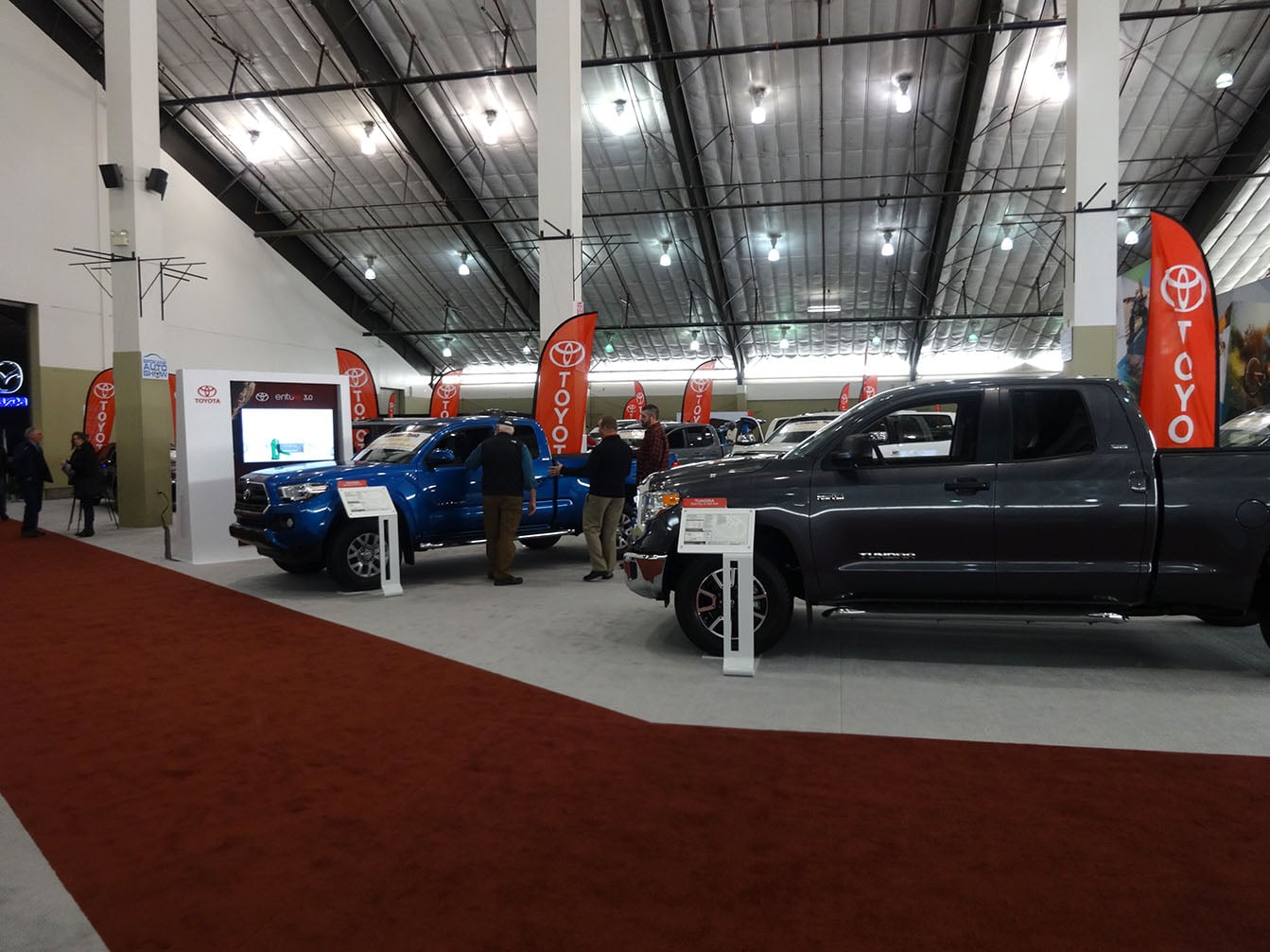 Trucks, freestanding signage and carpeted exhibit areas at the 2017 auto show.